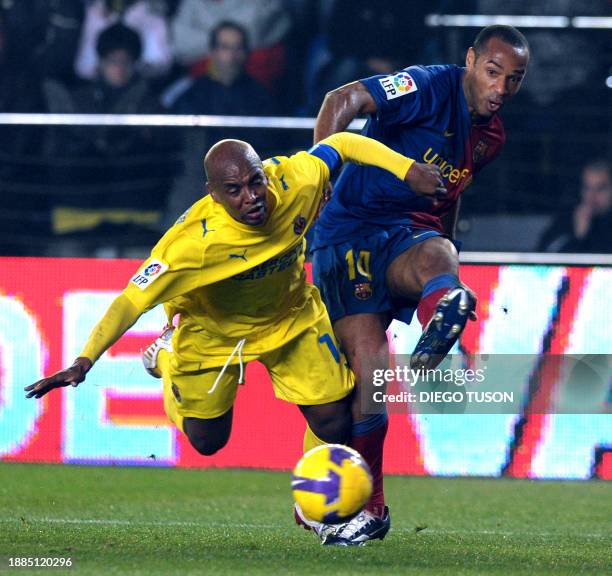 Villarreal's Marcos Sena fights for the ball with Barcelona's Thierry Henry during their Spanish league football match at Madrigal Stadium in...