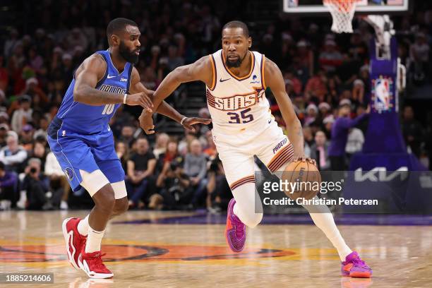 Kevin Durant of the Phoenix Suns handles the ball against Tim Hardaway Jr. #10 of the Dallas Mavericks during the second half of the NBA game at...