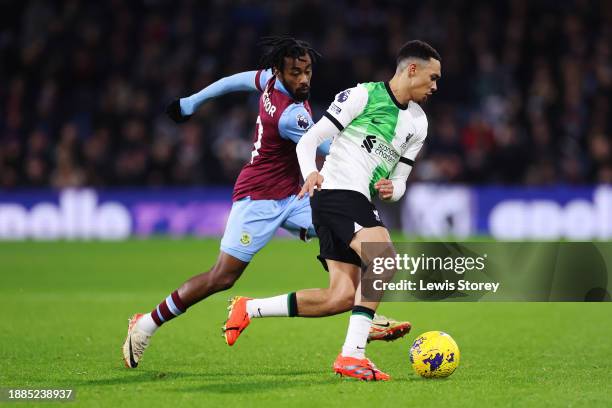 Trent Alexander-Arnold of Liverpool on the ball whilst under pressure from Mike Tresor Ndayishimiye of Burnley during the Premier League match...