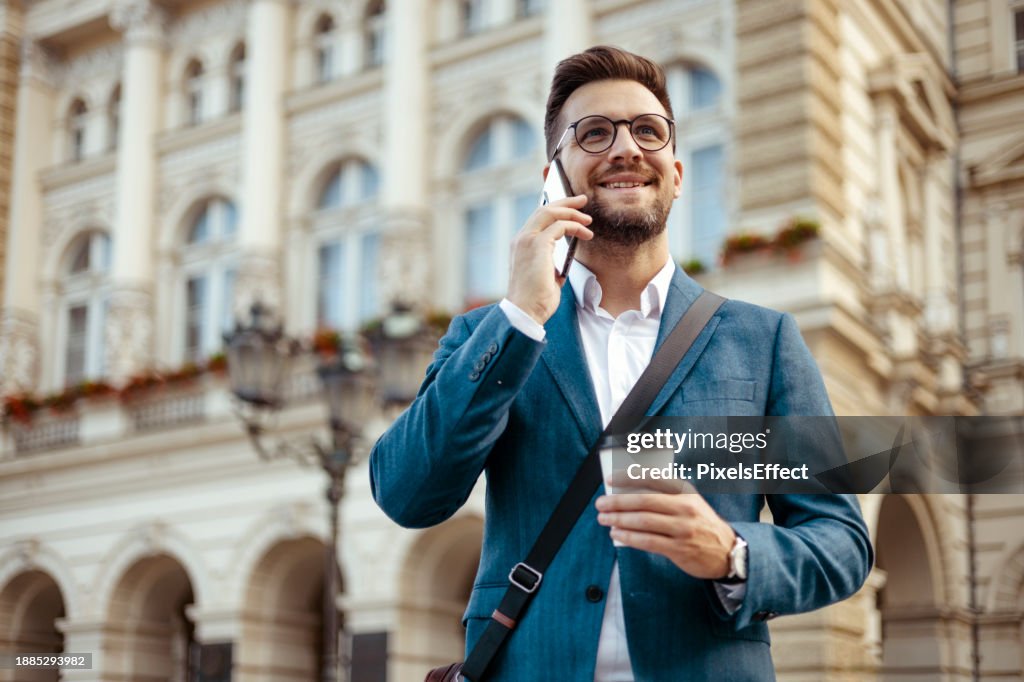 Businessman Talking on Smartphone in City Center