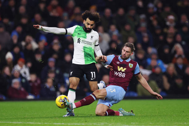 Mohamed Salah of Liverpool is tackled by Charlie Taylor of Burnley during the Premier League match between Burnley FC and Liverpool FC at Turf Moor...