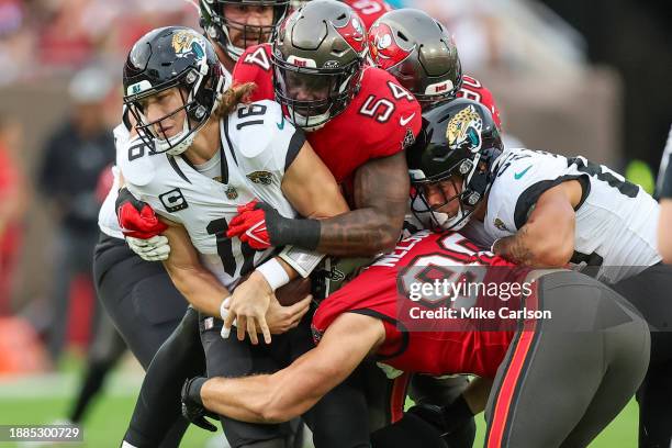 Lavonte David of the Tampa Bay Buccaneers sacks Trevor Lawrence of the Jacksonville Jaguars during the first half of the game at Raymond James...