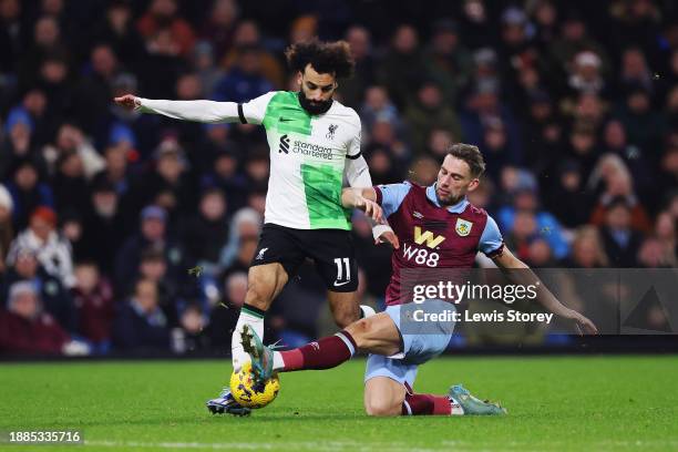 Mohamed Salah of Liverpool is tackled by Charlie Taylor of Burnley during the Premier League match between Burnley FC and Liverpool FC at Turf Moor...