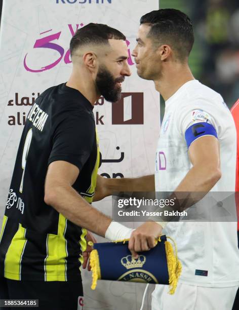 Karim Benzema of Al-Ittihad shakes hands with Cristiano Ronaldo of Al Nassr prior to the Saudi Pro League match between Al-Ittihad and Al-Nassr at...