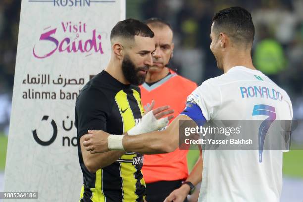 Karim Benzema of Al-Ittihad shakes hands with Cristiano Ronaldo of Al Nassr prior to the Saudi Pro League match between Al-Ittihad and Al-Nassr at...