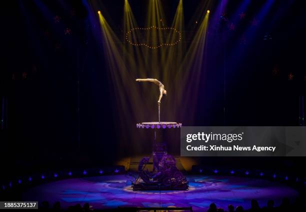 Acrobat Wang Mengchen of China's Jiangsu Acrobatic Troupe performs in Stuttgart, Germany, Dec. 28, 2023. An acrobatic performance by China's Jiangsu...