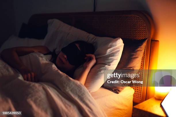 exhausted woman sleeping in eye mask after a long day - afterr stock pictures, royalty-free photos & images