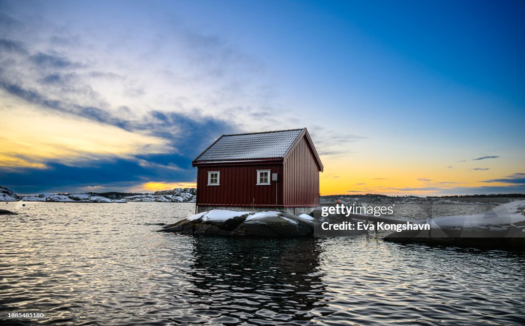 A red fishing house on an island