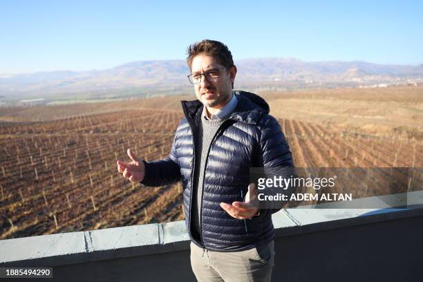 Director of the Vinkara winery, Candas Misir, gestures as he stands in front of his vineyard in Kalecik in the district of Ankara Province on...