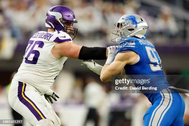 Aidan Hutchinson of the Detroit Lions competes against David Quessenberry of the Minnesota Vikings in the first half at U.S. Bank Stadium on December...