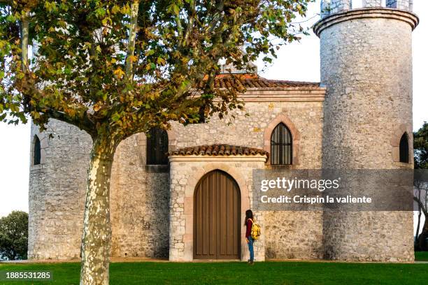 tourist visiting a catholic church. - llanes stock pictures, royalty-free photos & images