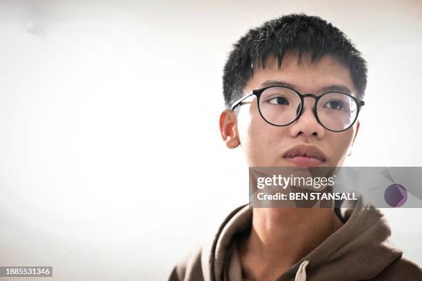 Hong Kong democracy activist Tony Chung poses in a bedroom in Britain on December 29, 2023 after fleeing Hong Kong. The Hong Kong activist said on...