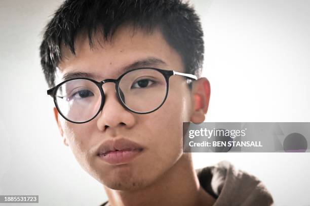 Hong Kong democracy activist Tony Chung poses in a bedroom in Britain on December 29, 2023 after fleeing Hong Kong. The Hong Kong activist said on...