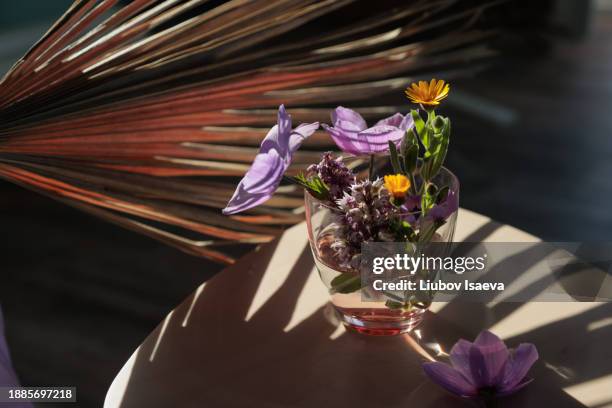 high angle view of spring bouquet of lilac, yellow wildflowers. still life - anemone flower arrangements stock pictures, royalty-free photos & images