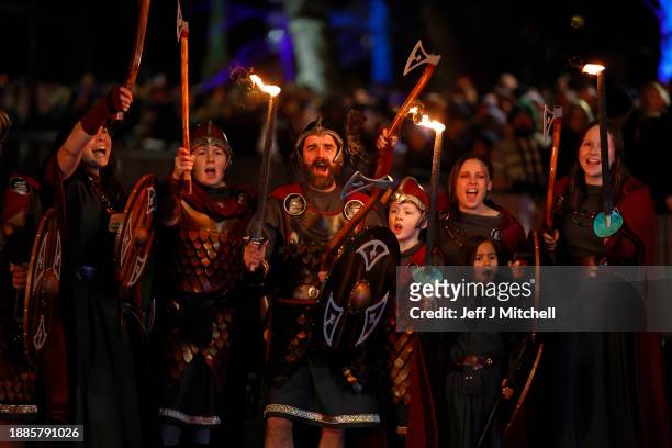 Vikings from Shetland’s South Mainland Up Helly Aa Jarl Squad pose for photographs before leading the Torchlight Procession through Edinburgh city...