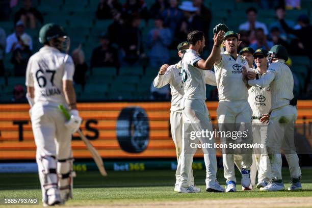 Team mates congratulating Mitch Starc of Australia as he dismisses Salman Ali Agha of Pakistan during Day 4 of the Boxing Day Test - Day 4 match...