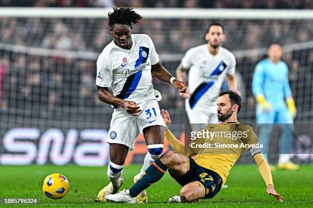 Yann Bisseck of Inter and Milan Badelj of Genoa vie for the ball during the Serie A TIM match between Genoa CFC and FC Internazionale at Stadio Luigi...
