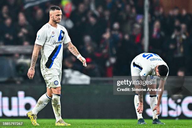 Marko Arnautovic and Alessandro Bastoni of Inter react with disappointment after Radu Dragusin of Genoa has scored a goal during the Serie A TIM...