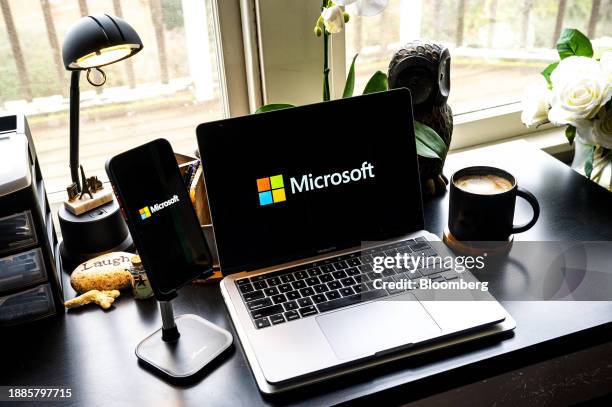 The Microsoft logo on a smartphone and laptop arranged in Crockett, California, US, on Friday, Dec. 29, 2023. Microsoft has invested some $13 billion...