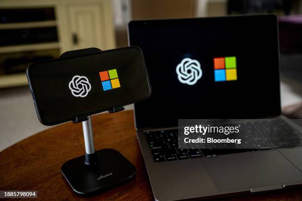 The OpenAI and Microsoft logos on a smartphone and laptop arranged in Crockett, California, US, on Friday, Dec. 29, 2023. Microsoft has invested some...