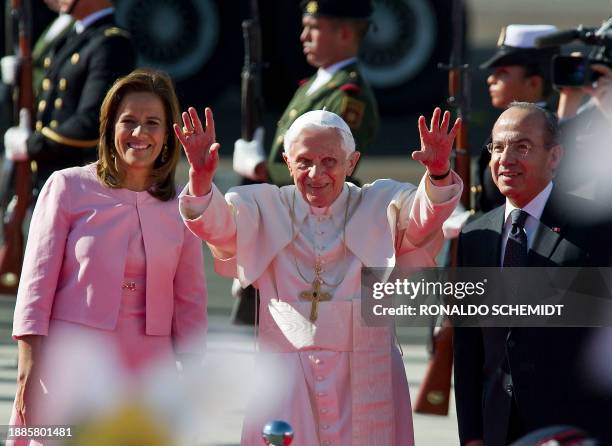 Pope Benedict XVI waves next to Mexican President Felipe Calderon and his wife Margarita Zavala, upon his arrival at Silao's international airport in...