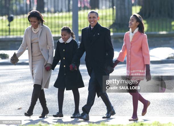 President Barack Obama, First Lady Michelle Obama and their daughters, Sasha and Malia walk from the White House through Lafayette Park to attend...