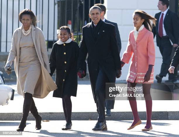 President Barack Obama, First Lady Michelle Obama and their daughters, Sasha and Malia walk from the White House through Lafayette Park to attend...