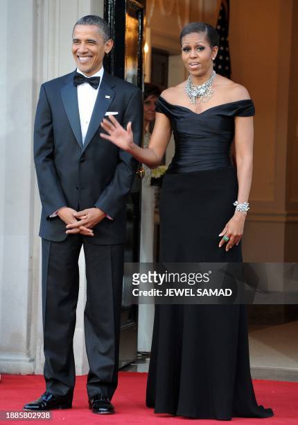 President Barack Obama and First Lady Michelle Obama wait to greet Britain's Queen Elizabeth II and Prince Philip, the Duke of Edinburgh, for a...