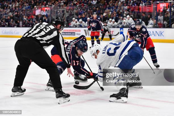 Justin Danforth of the Columbus Blue Jackets and David Kampf of the Toronto Maple Leafs battle for the puck in a face-off during the first period of...