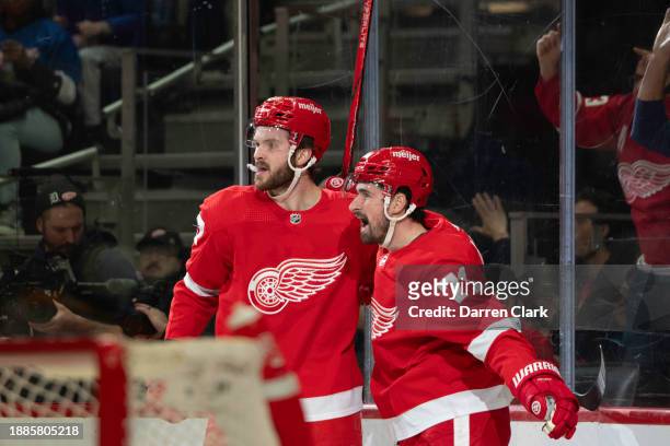 Dylan Larkin of the Detroit Red Wings celebrates his goal with teammate Michael Rasmussen during the first period against the Nashville Predators at...