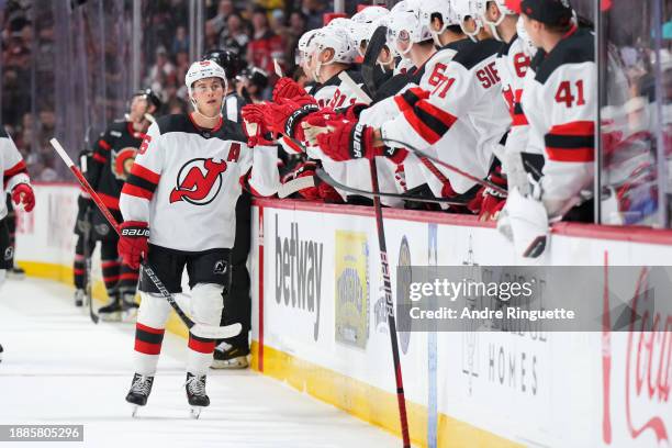 Jack Hughes of the New Jersey Devils celebrates his first period goal against the Ottawa Senators with teammates at the players' bench at Canadian...