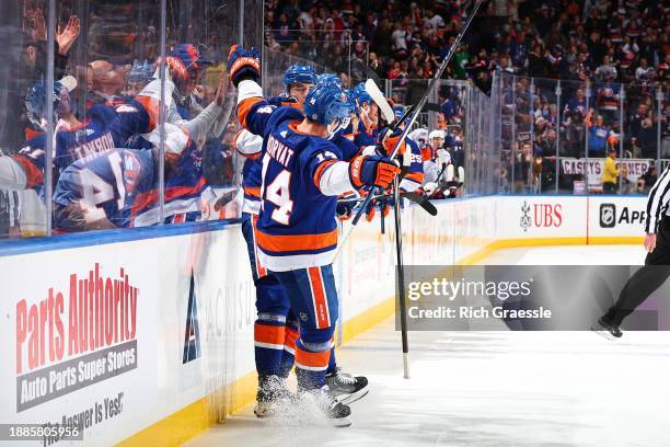 Noah Dobson of the New York Islanders celebrates with teammates after scoring during the second period the game against the Washington Capitals on...