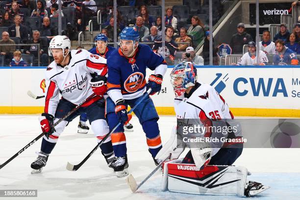 Darcy Kuemper of the Washington Capitals defends his net with Kyle Palmieri of the New York Islanders in front during the second period on December...