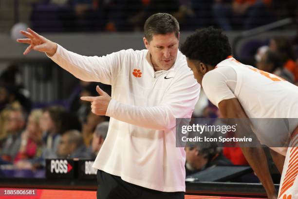 Clemson Tigers head coach Brad Brownell gives instruction to Clemson Tigers forward Chauncey Wiggins during a college basketball game between the...
