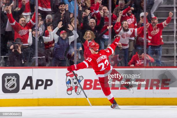 Lucas Raymond of the Detroit Red Wings celebrates his game winning goal in O.T on Juuse Saros of the Nashville Predators at Little Caesars Arena on...