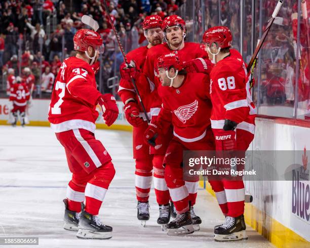 Alex DeBrincat of the Detroit Red Wings celebrates his goal on Juuse Saros of the Nashville Predators with teammates during the third period at...