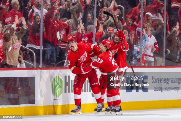 Lucas Raymond of the Detroit Red Wings celebrates his game winning goal in O.T on Juuse Saros of the Nashville Predators at Little Caesars Arena on...