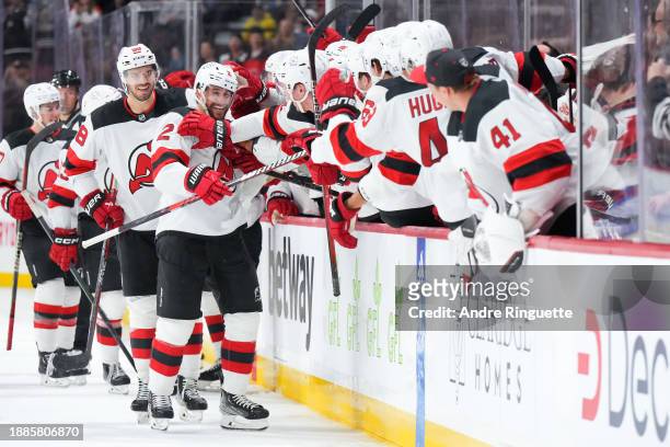 Brendan Smith of the New Jersey Devils celebrates his third period goal against the Ottawa Senators with teammates at the players' bench at Canadian...