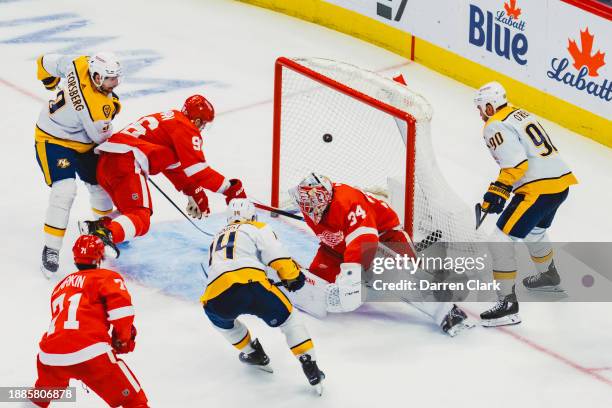 Gustav Nyquist of the Nashville Predators scores on goalie Alex Lyon of the Detroit Redwings during the third period at Little Caesars Arena where...