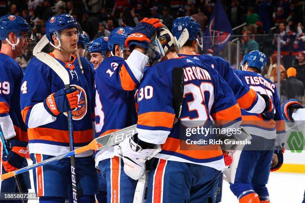 Ilya Sorokin of the New York Islanders celebrates with teammates after winning the game against the Washington Capitals on December 29, 2023 at UBS...