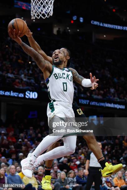 Damian Lillard of the Milwaukee Bucks scores past Isaac Okoro of the Cleveland Cavaliers during the second half at Rocket Mortgage Fieldhouse on...