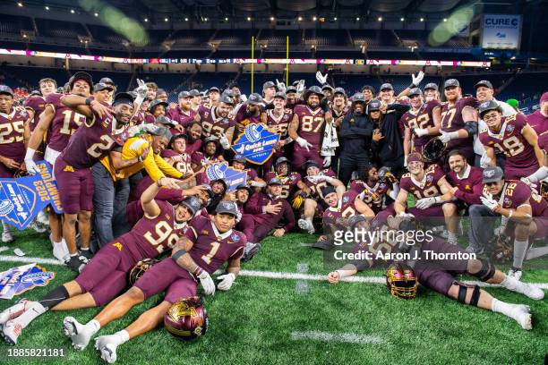The Minnesota Golden Gophers football team pose for a team photo after winning the Quick Lane Bowl against the Bowling Green Falcons at Ford Field on...
