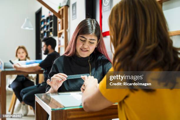 woman in beauty salon getting her nails done - kumanovo stock pictures, royalty-free photos & images