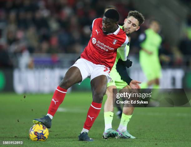 Christ Tiehi of Rotherham United and Adil Aouchiche of Sunderland in action during the Sky Bet Championship match between Rotherham United and...