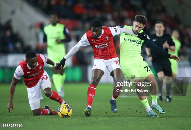 Christ Tiehi of Rotherham United and Adil Aouchiche of Sunderland in action during the Sky Bet Championship match between Rotherham United and...