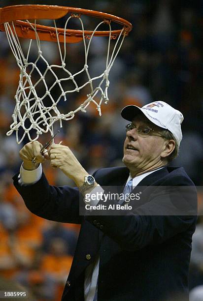 Head coach Jim Boeheim of the Syracuse Orangemen cuts down the net after defeating the Oklahoma Sooners 63-47 during the East Regionals of the NCAA...