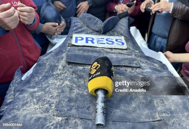 Al-Quds TV journalist Cebr Abu Hedrus', who died in Israeli attacks on Nuseirat refugee camp, vest and microphone are seen during his funeral...