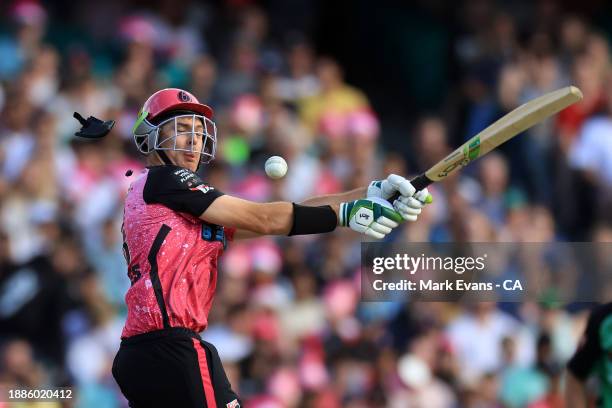 Daniel Hughes of the Sixers is hit on the helmet during the BBL match between Sydney Sixers and Melbourne Stars at Sydney Cricket Ground, on December...