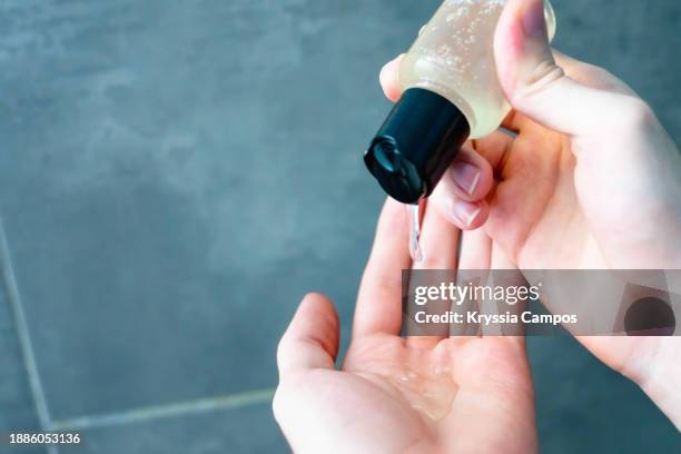 personal perspective of a male hands holding a shampoo or liquid soap - washing hair stock pictures, royalty-free photos & images