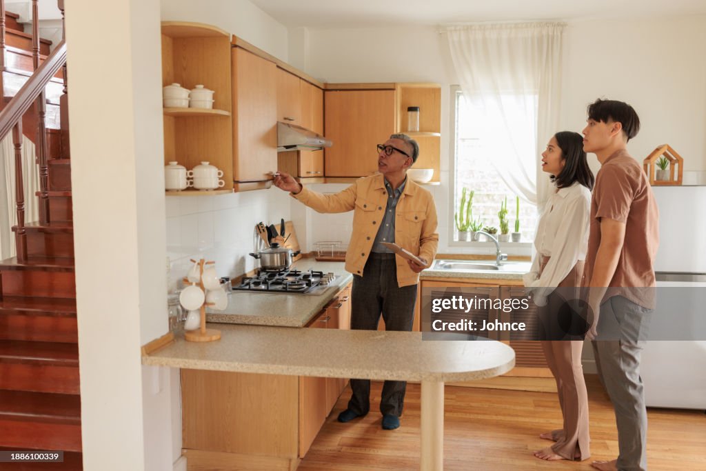 Real estate agent assisting homebuyers in house viewing